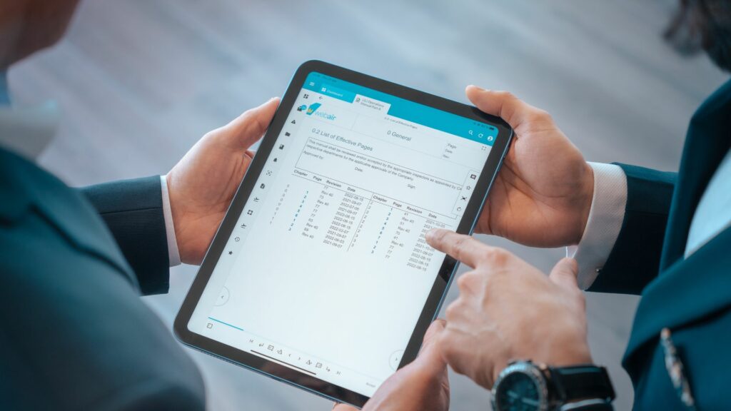 Two hands showing the Web Manuals platform